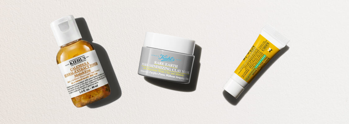 Tre Kiehl's hudplejeprodukter på en lys baggrund: Calendula-toner, Rare Earth-lermaske og en lille gul tube.
