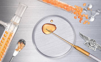 A flat lay image featuring laboratory equipment, including glass tubes with orange crystals, a petri dish with a golden substance, and a small spoon, all arranged on a metallic surface. Kiehl's logo is visible in the bottom right corner.