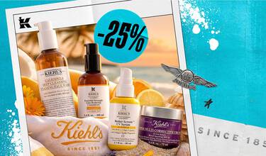 Kiehl's hudplejeprodukter, inklusive ansigtsvask, serum og creme, sat op mod en smuk solnedgang på stranden.