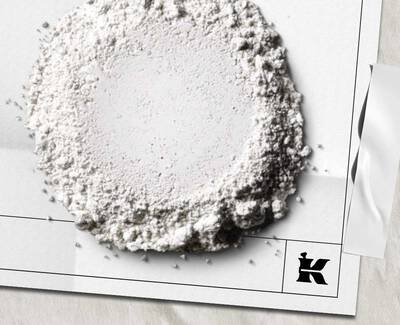 Close-up of a textured white surface with varying shades and rough patches of white powder.