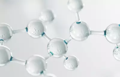 Close-up of transparent molecular structures, featuring spherical shapes interconnected by slender links, creating a sense of depth and scientific detail.