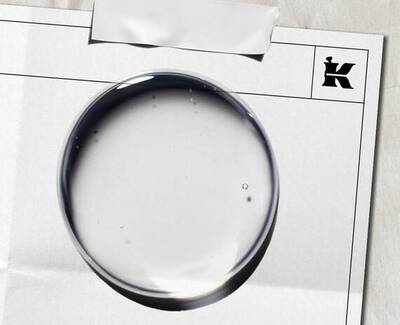 Close-up of translucent bubbles on a light blue background, displaying varying sizes and shapes.