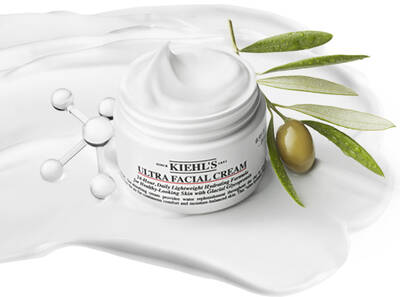 Kiehl's Ultra Facial Cream jar with a creamy texture and olive branch, highlighting hydration and skincare benefits.