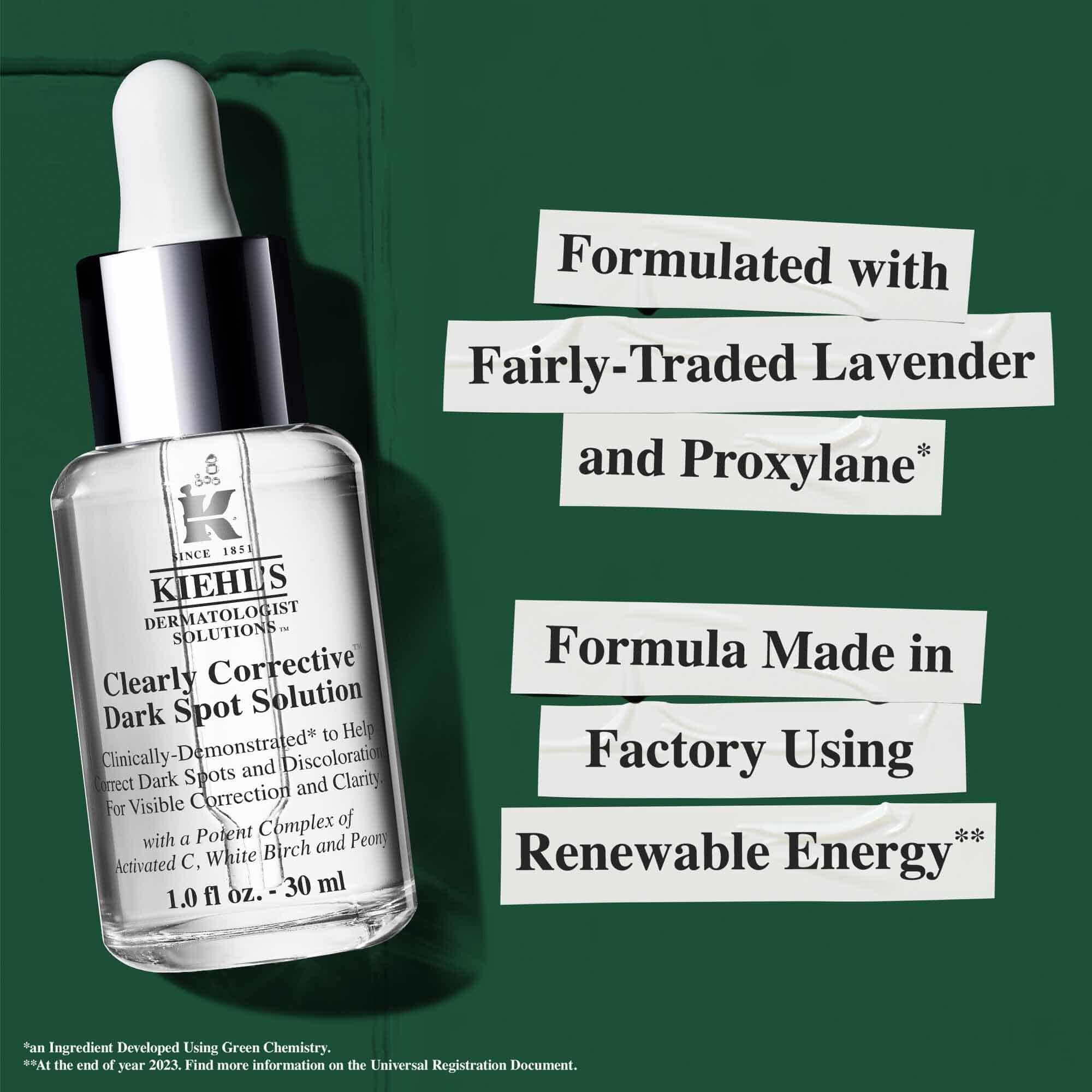 Flaske med Clearly Corrective Dark Spot Solution med baeredygtighedsanprisninger vedrørende vedvarende energi og genbrugsglas.