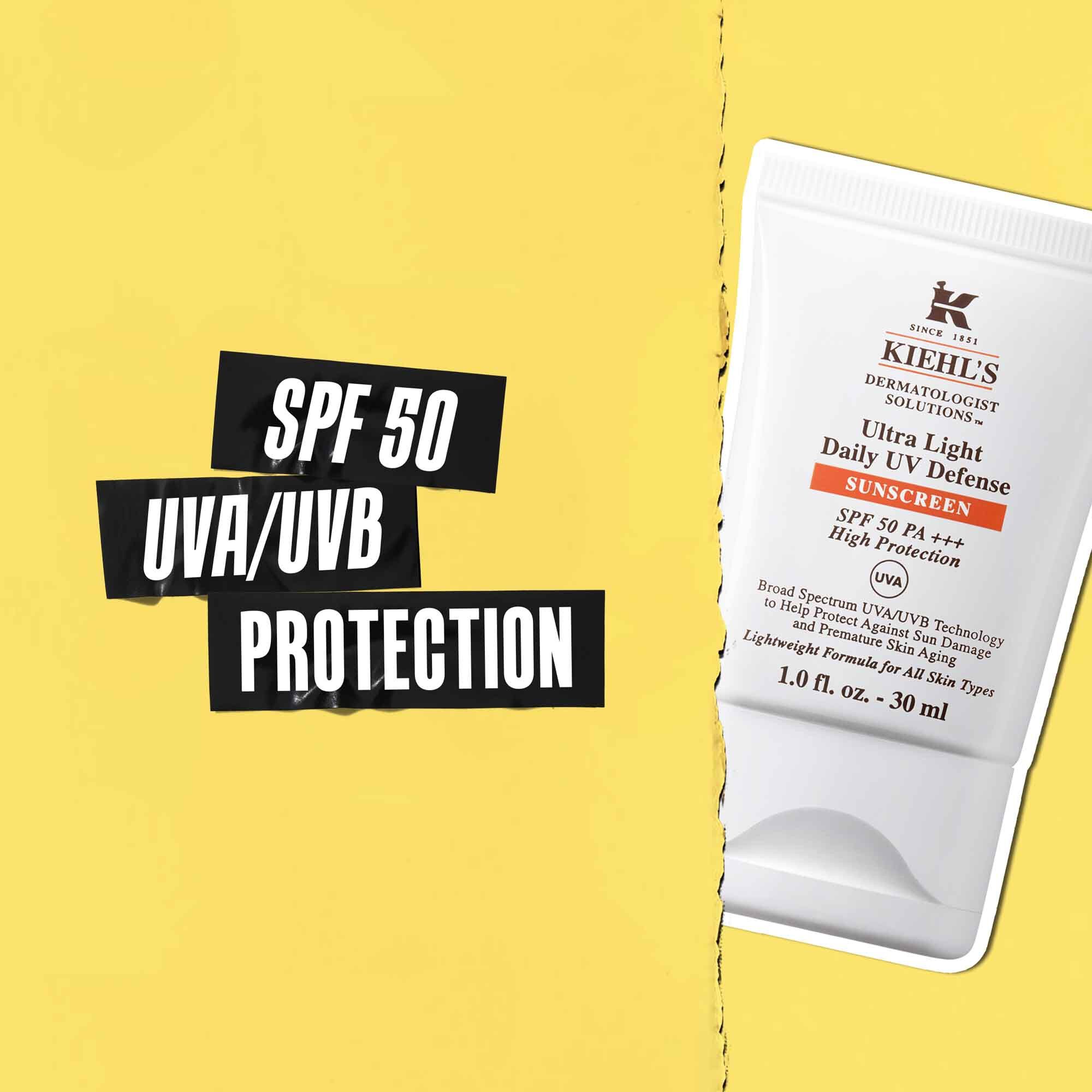 Fremhaevelse af SPF 50 UVA/UVB-beskyttelse på sort tape med et billede af Ultra-Light Daily UV Defense-tuben ved siden af.