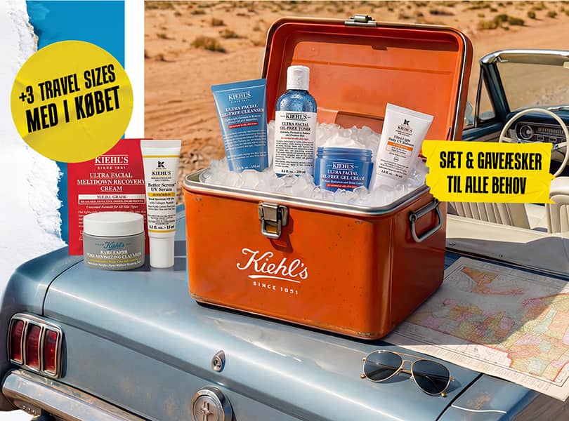Set Kiehl's Oil-Free Essentials dans une glacière vintage sur une voiture bleue, entouré de glace et d'une carte.
