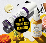 Kiehl's hudplejeprodukter på en lys gul baggrund, omgivet af blomster og illustrationer af fugle. Tilbud på rejsestørrelser inkluderet.