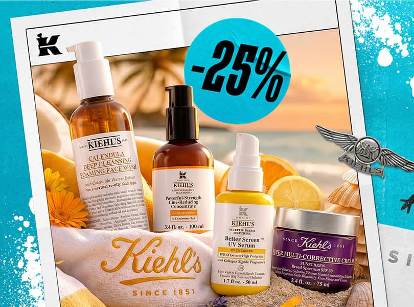 Kiehl's hudplejeprodukter, inklusive ansigtsvask, serum og creme, sat op mod en smuk solnedgang på stranden.